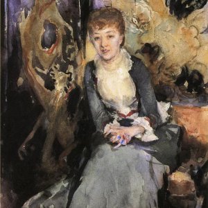 Miss. Reubell Seated In Front Of A Screen
